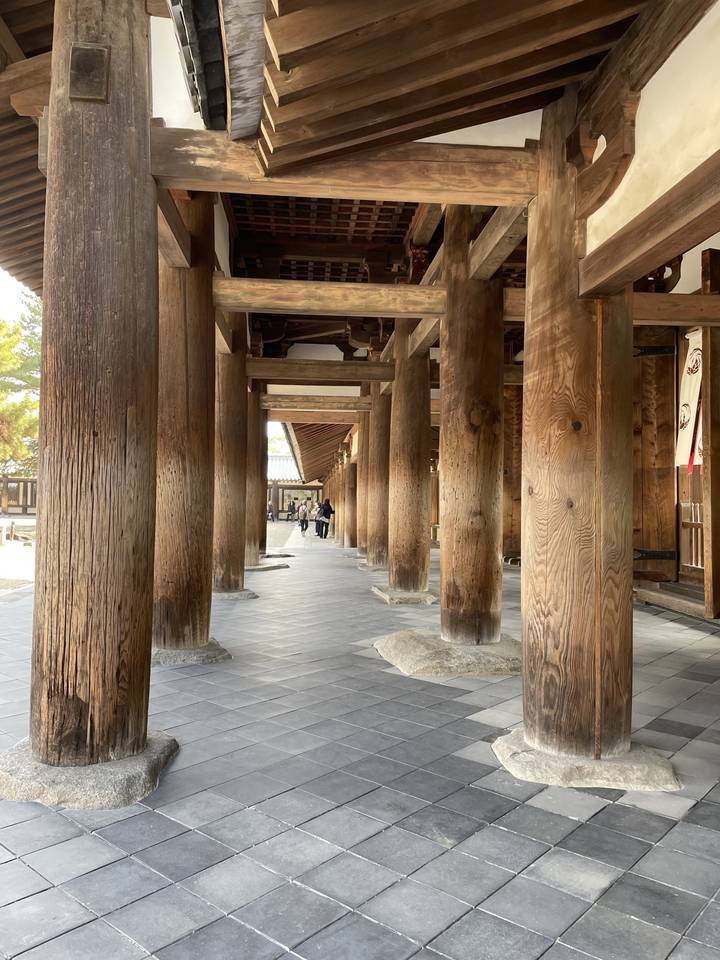 Wooden pillars inside a traditional Japanese structure.