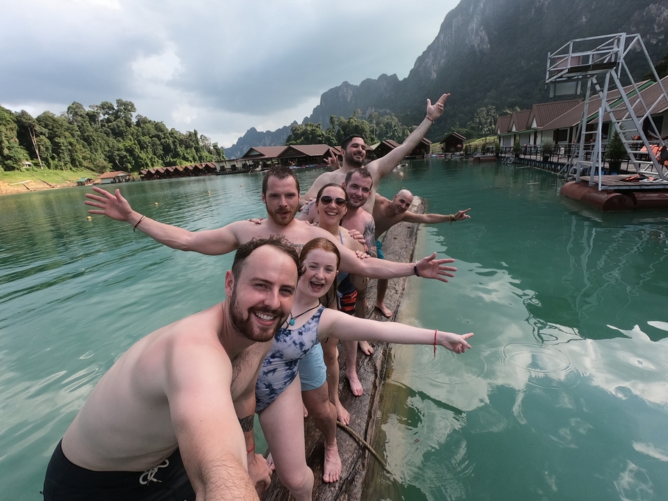 Group of people in a pool water enjoying and posing.