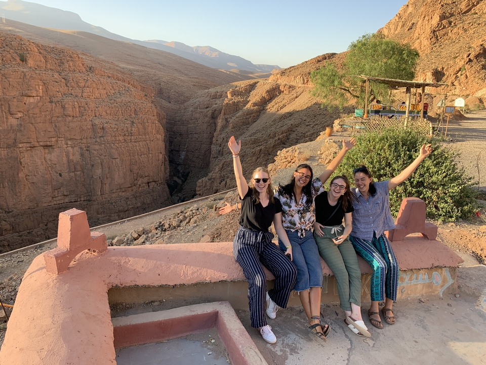 Group of women posing with a canyon in the background.
