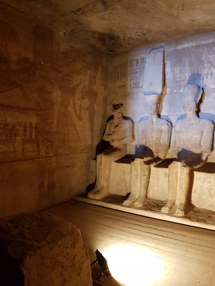 Interior of a temple with statues and carvings.