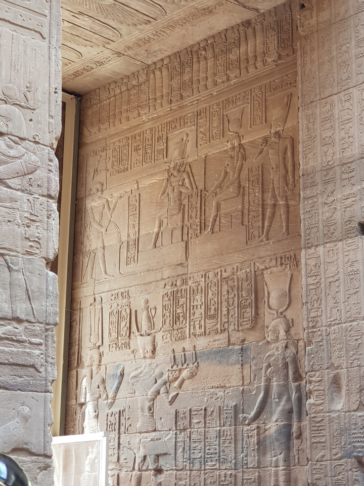 Hieroglyphic carvings on a stone wall.