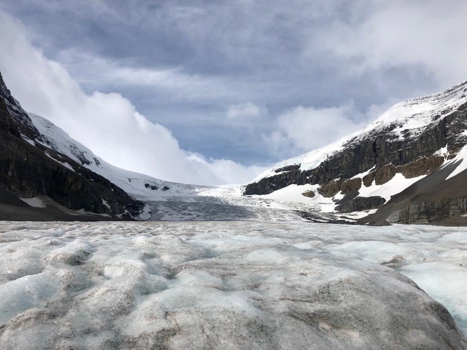 Expansive glacier with mountains in the background.