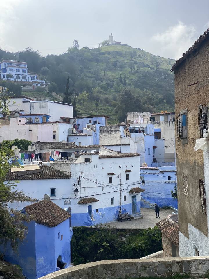 View of a blue-colored town on a hillside.