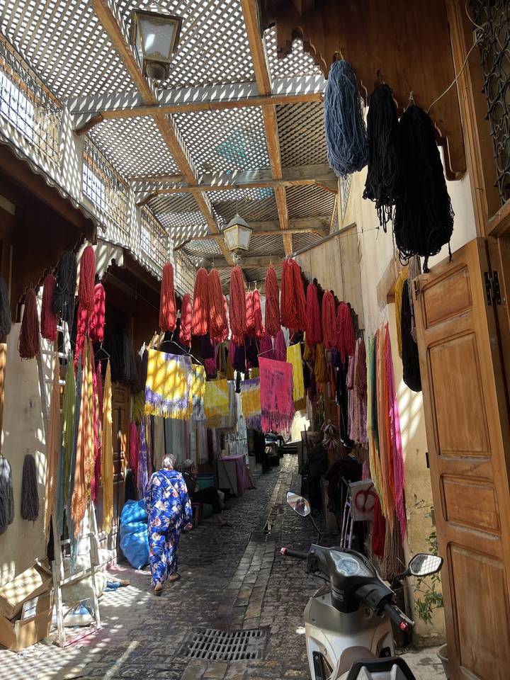 Colorful textiles hanging in a market.