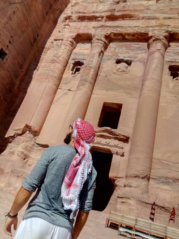 Person looking at the facade of Petra.