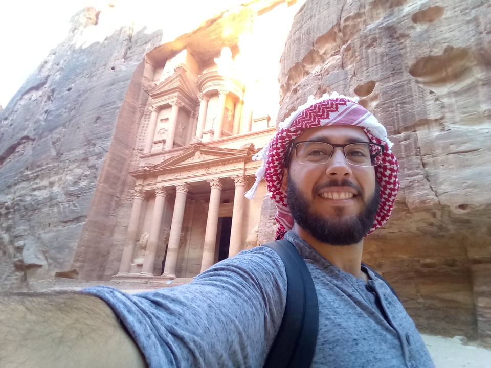Person taking a selfie with Petra's Treasury in the background.