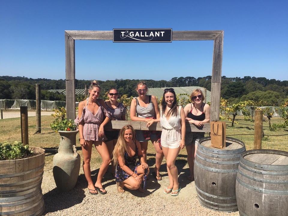 Group of people standing outside a winery.