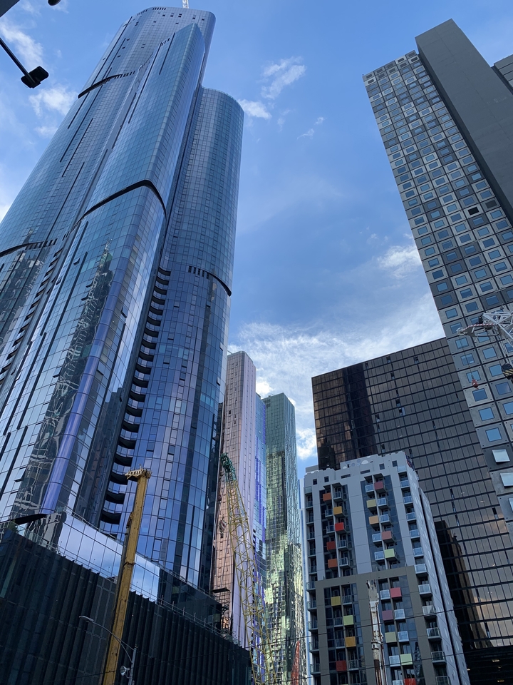 Modern skyscrapers tower against a blue sky.