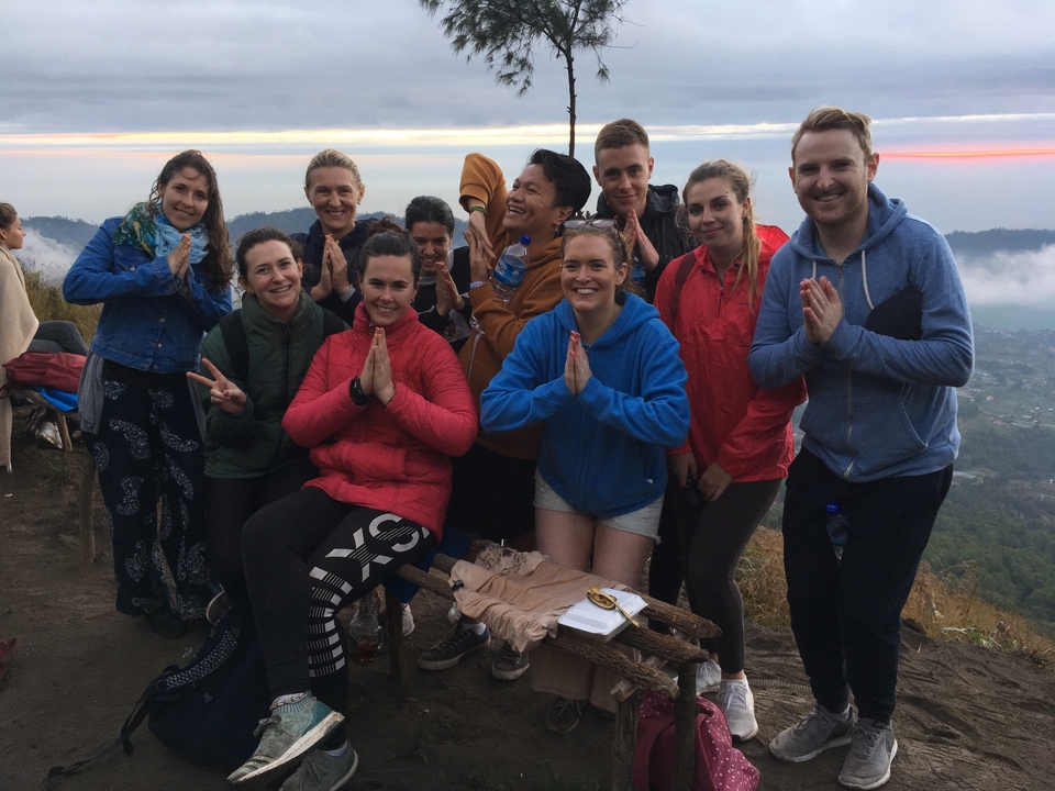 Group of people posing during a scenic early morning hike.