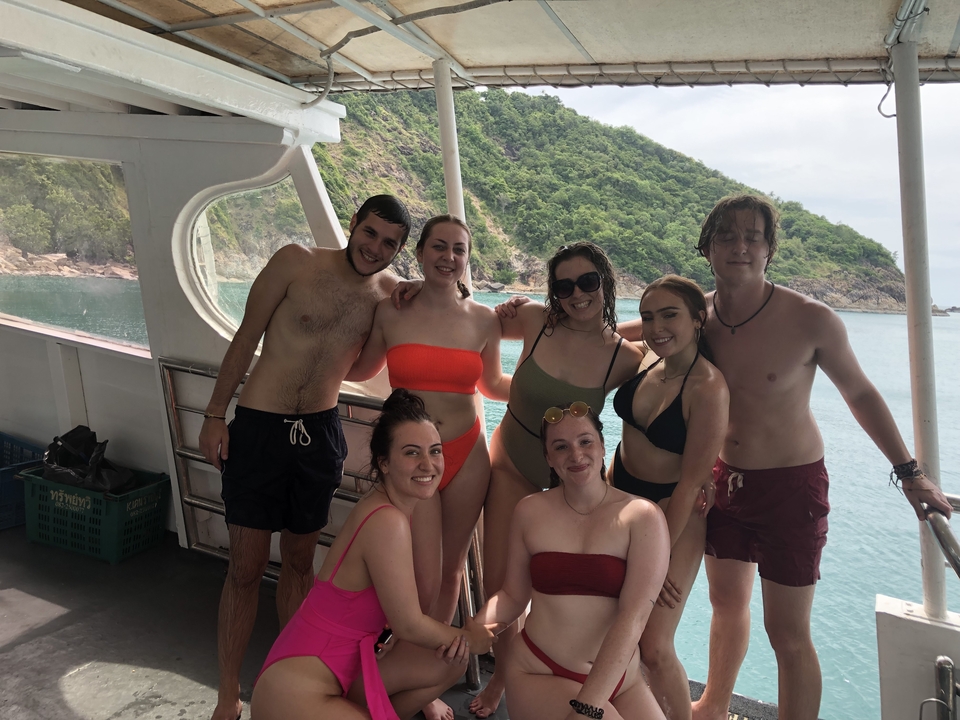 Group of friends on a boat with sea as background