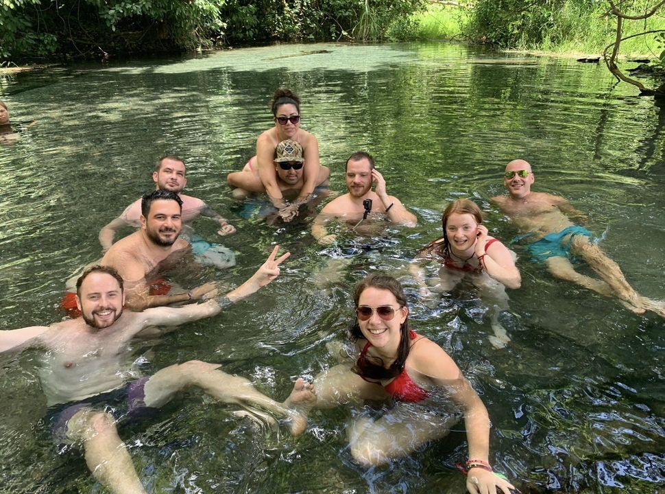Group of people relaxing in a natural pool.