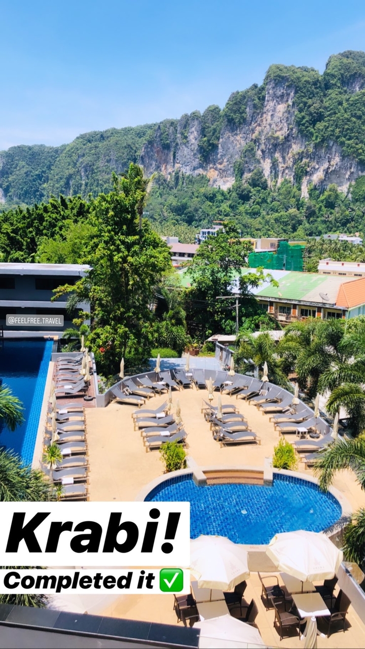 A resort view with a swimming pool and trees, marked with overlay text.