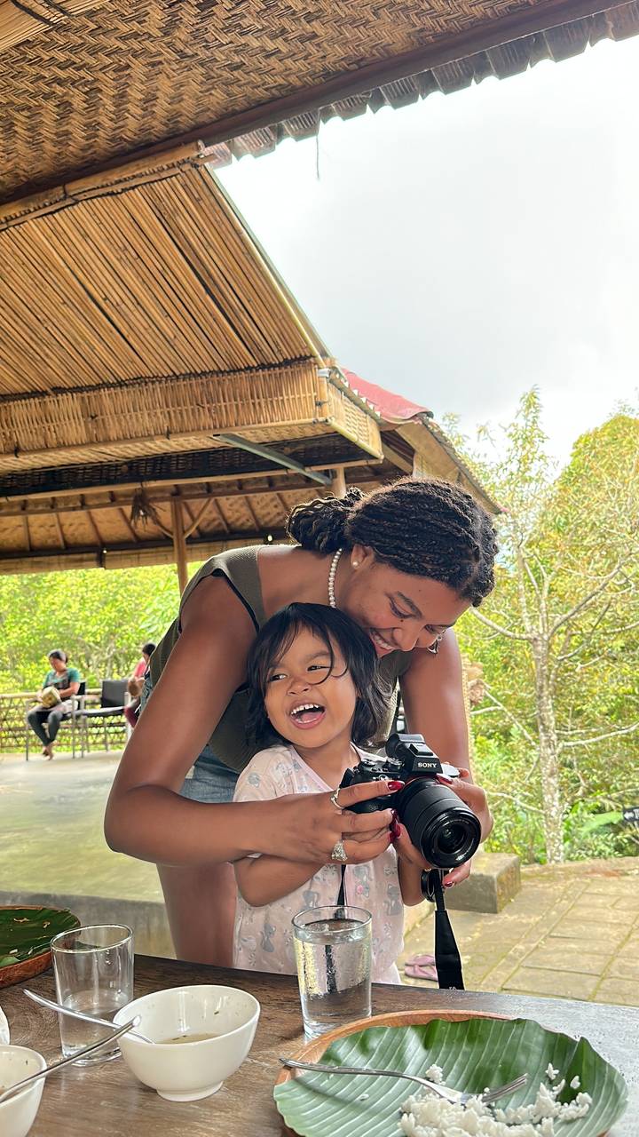 Woman and child playing with a camera.