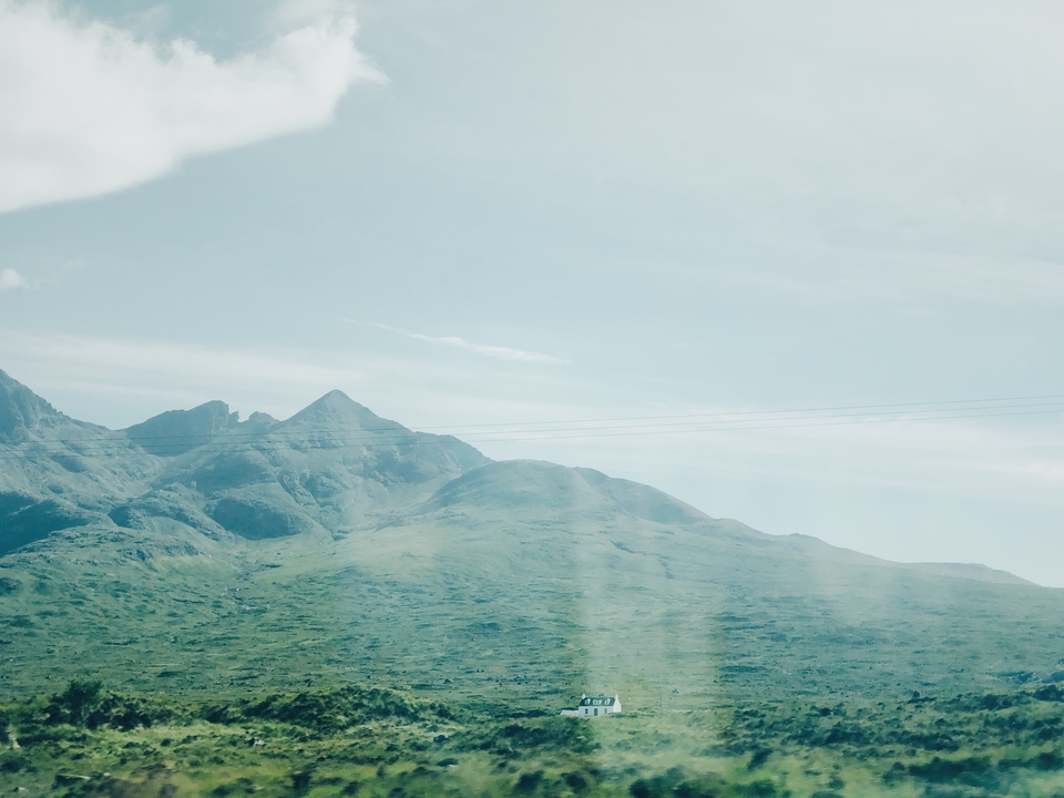 Mountains with a slightly hazy sky and power lines.