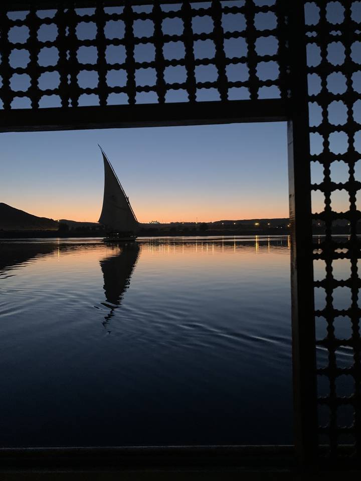 Boat sailing on a river at sunset.