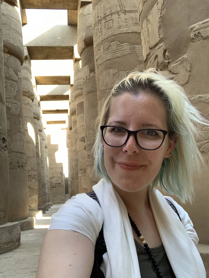 Person taking a selfie inside a historical site.
