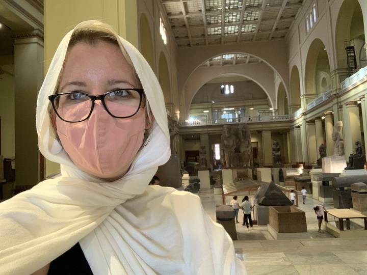 Person with a mask in a museum setting.