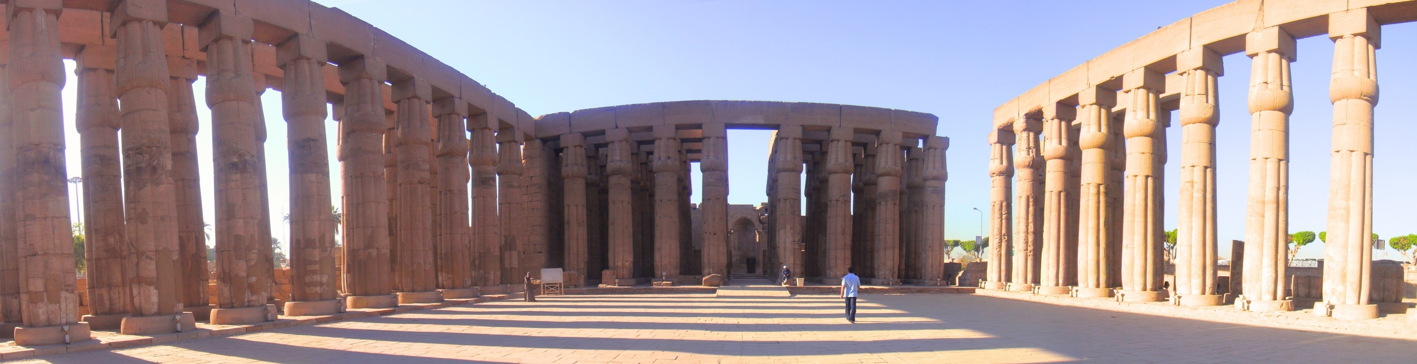 Massive columns and open courtyard in an ancient temple complex.