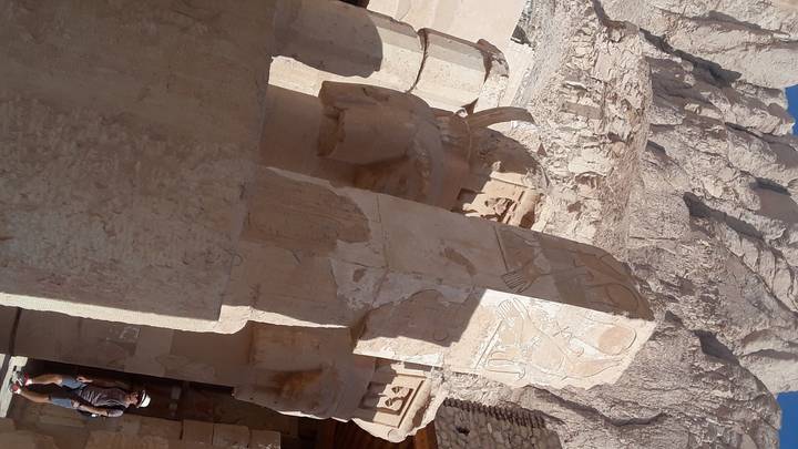 Close-up of worn-out ancient wall with carvings.