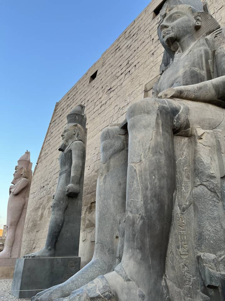 Huge stone statues at an ancient Egyptian temple site.