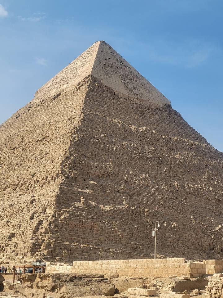Side view of a pyramid with a blue sky background.