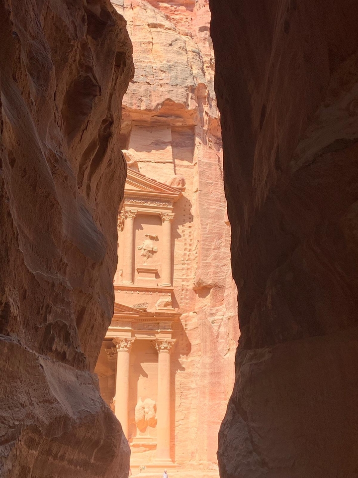 The Treasury at Petra viewed through a narrow canyon.