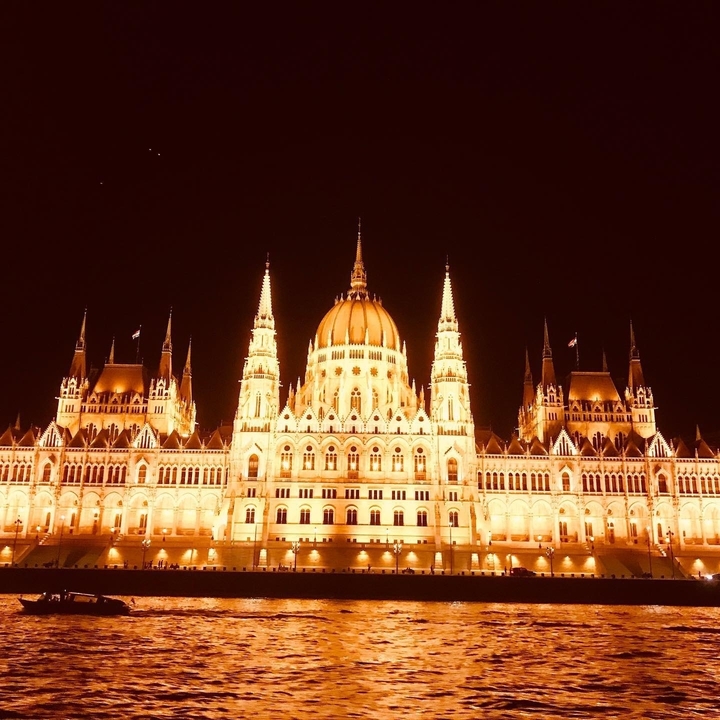 Illuminated Parliament Building in Budapest at night.