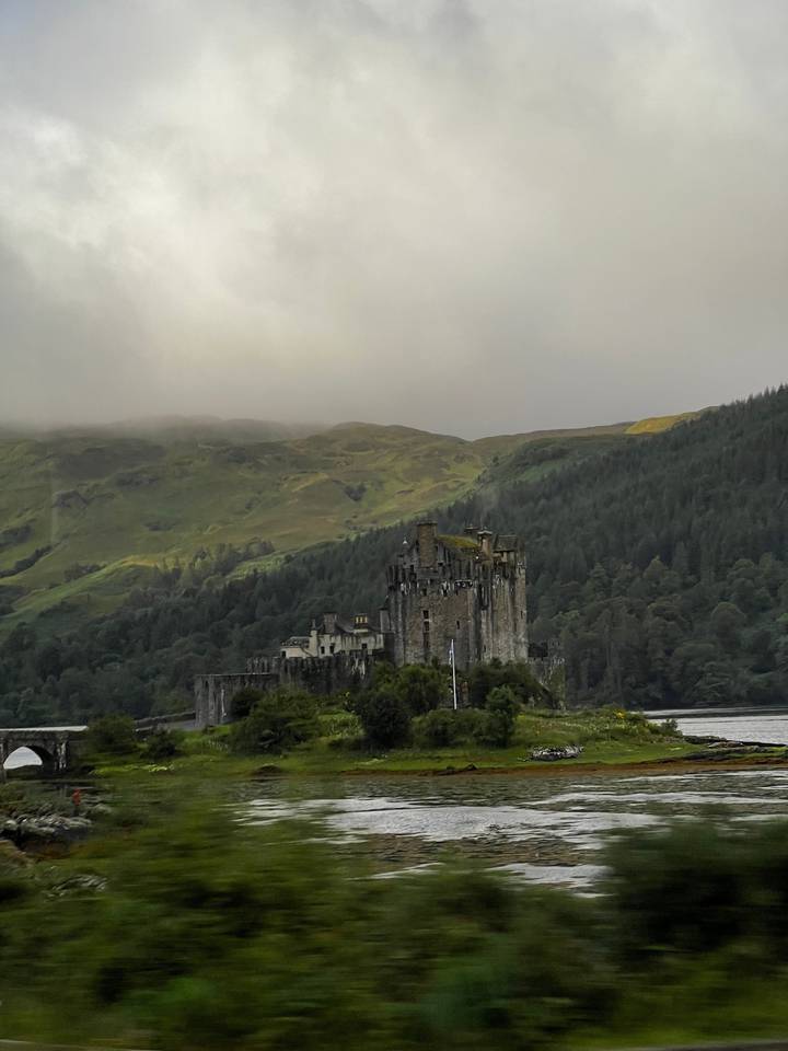 Castle in the distance with hills and greenery.