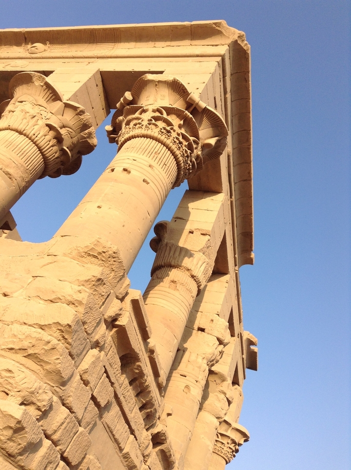 Ancient columns and structures under blue sky