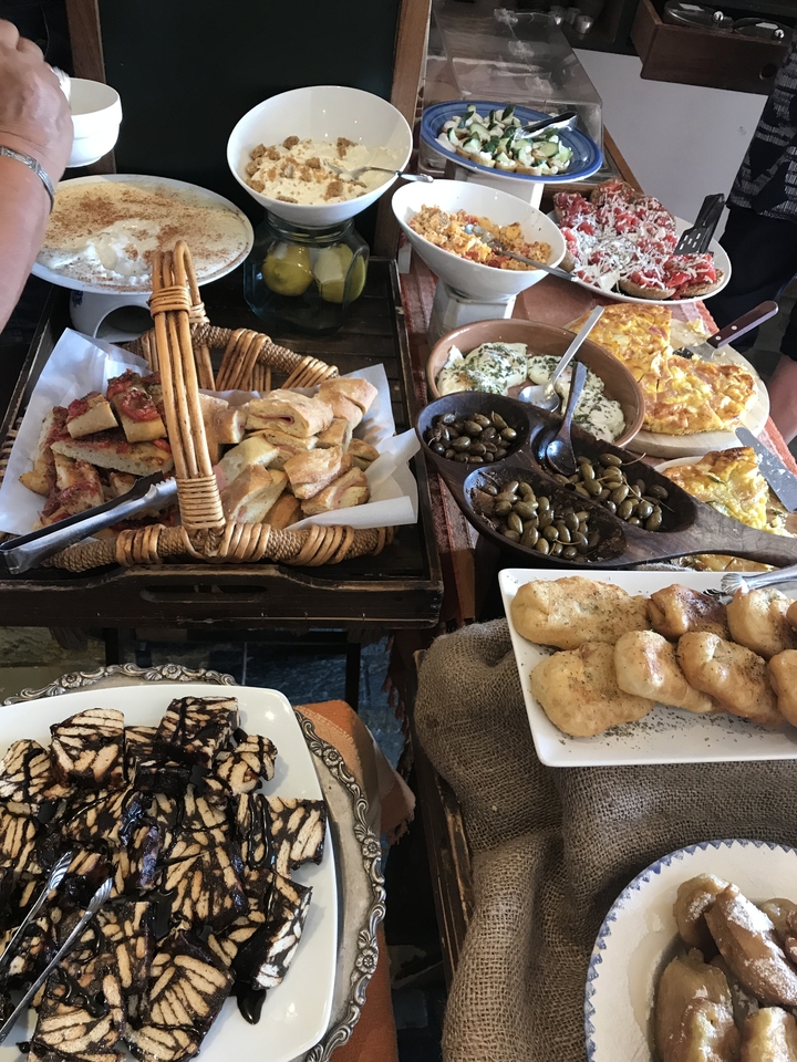 A variety of local Greek delicacies displayed on a table.