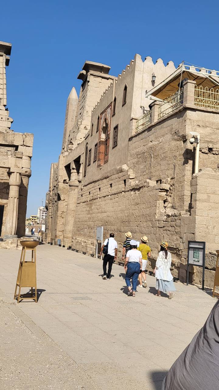 Tourists walking through an ancient ruin.