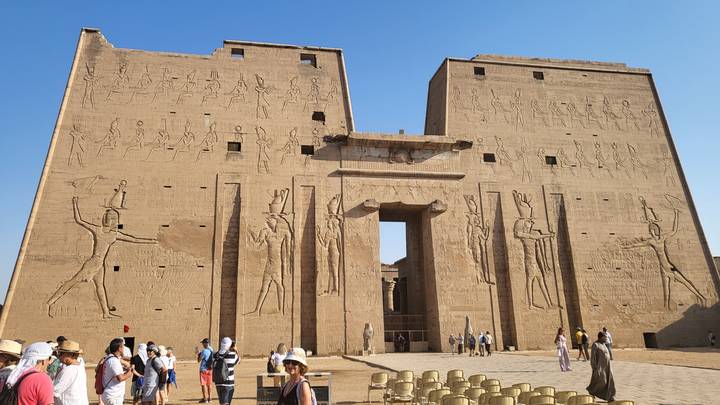 Upside-down view of an ancient temple with large carvings.