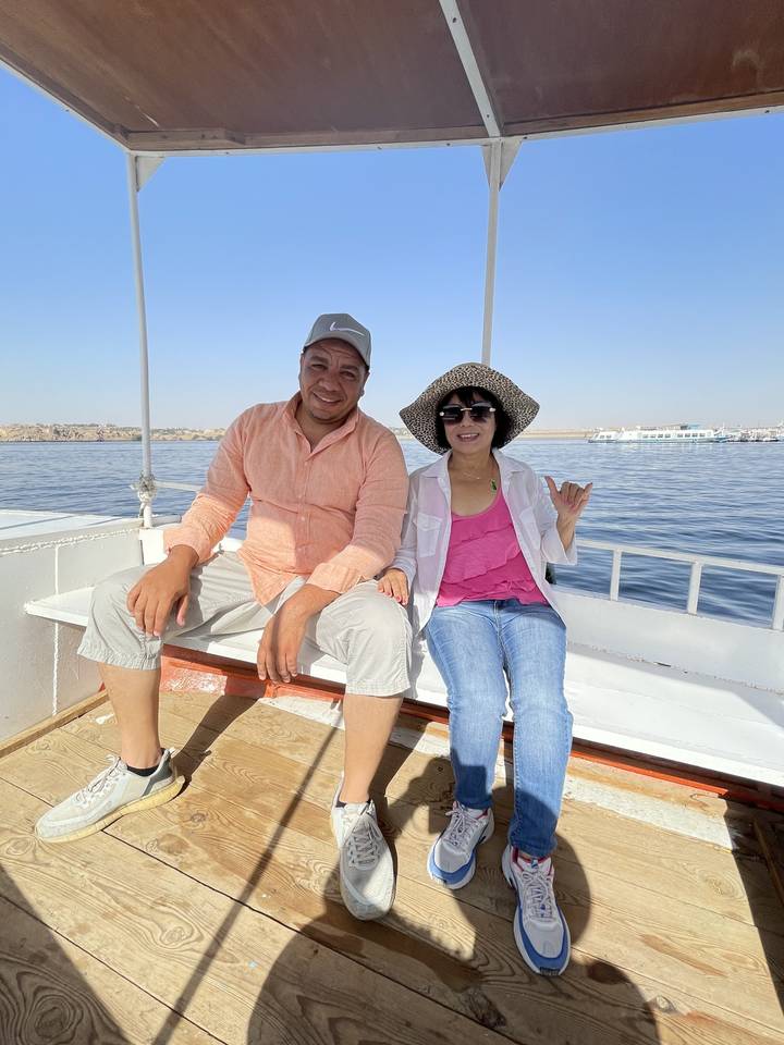 Two people on a boat deck enjoying the journey.