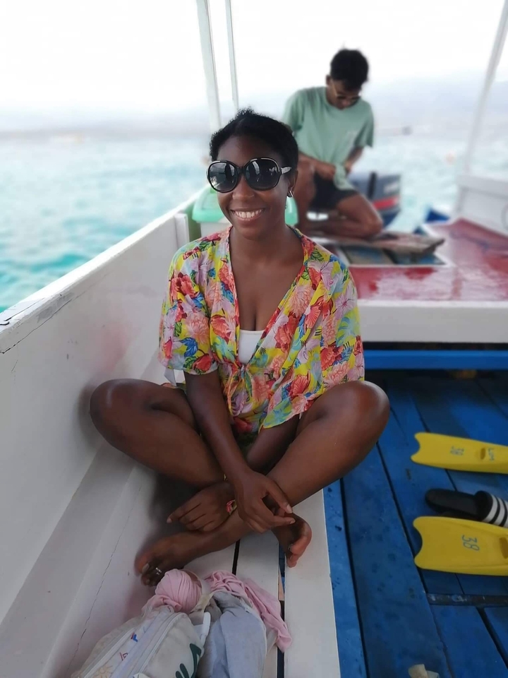 Person sitting on a boat enjoying the scenery.