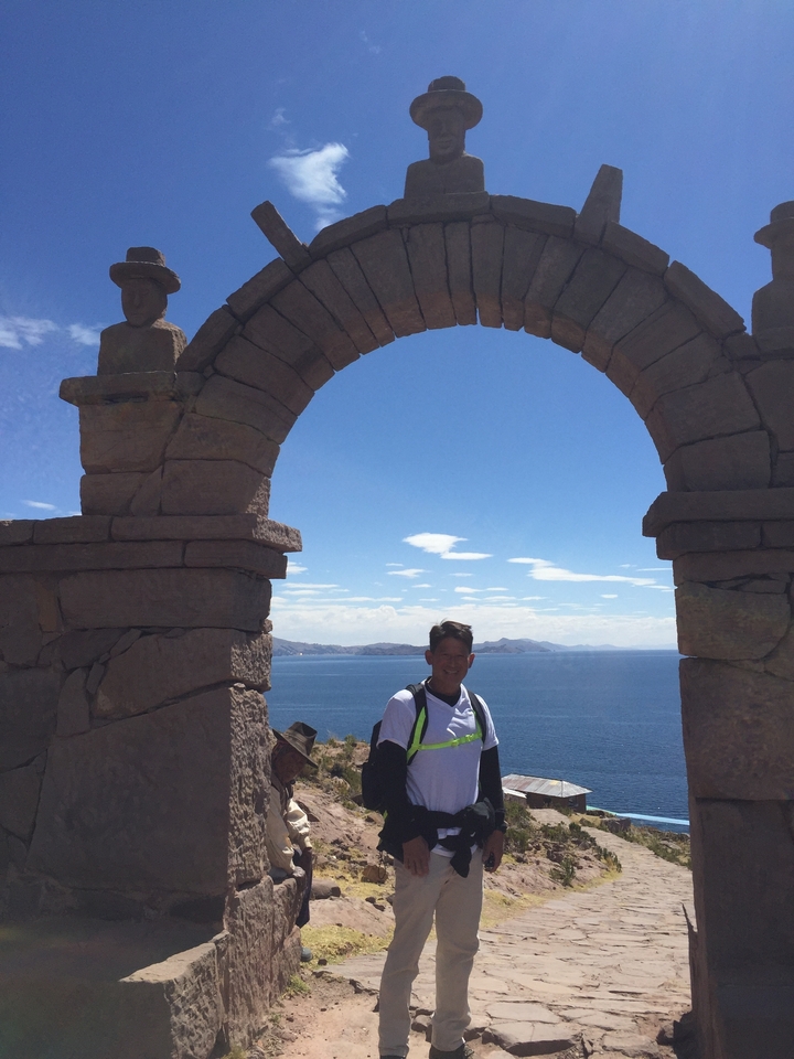 Two men presenting a map on a floating reed island.