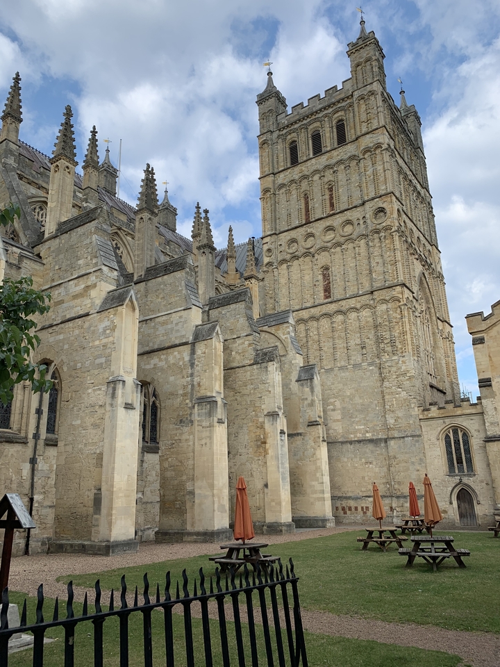 Side view of a cathedral with spires and arches.