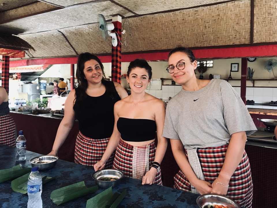 Three women participating in a cooking class.