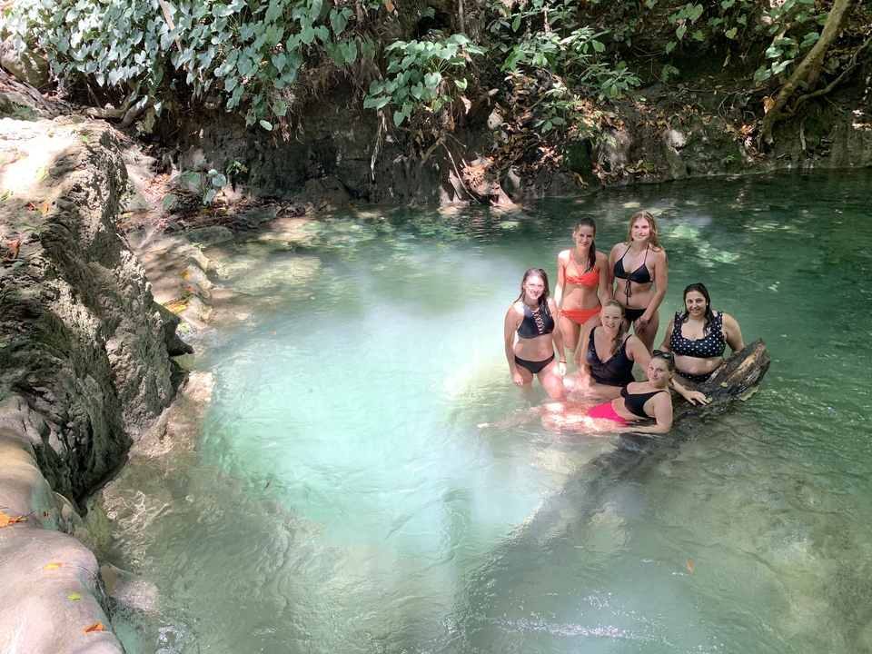 Group of women relaxing in a natural pool.
