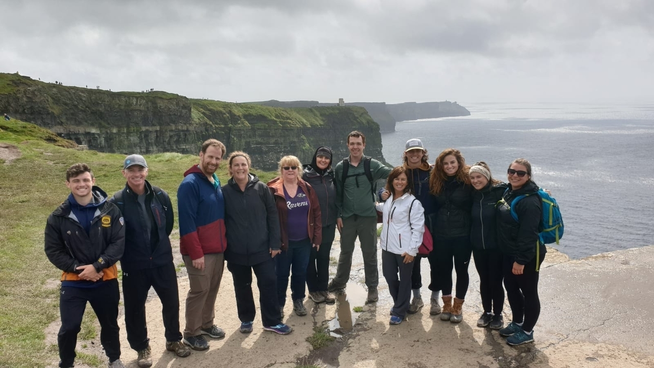 Group of people posing at Cliffs of Moher
