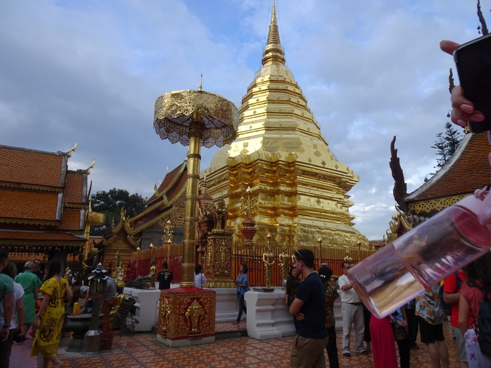 Golden temple with people around it.