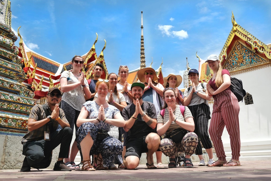 Group posing with a temple in the background.
