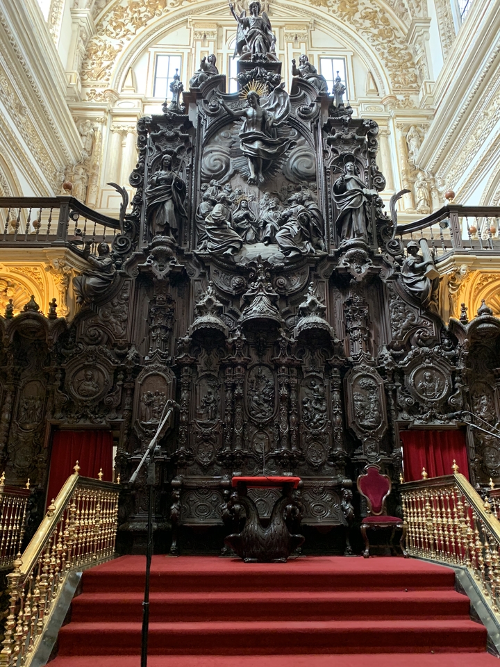 Detailed wood carvings with religious motifs in a church context.