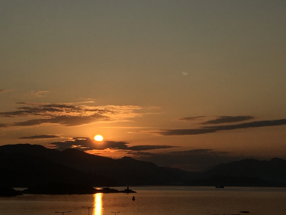Sunset over mountains and clouds.