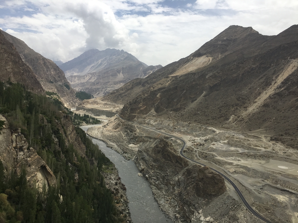 An expansive view of a river valley surrounded by mountains.