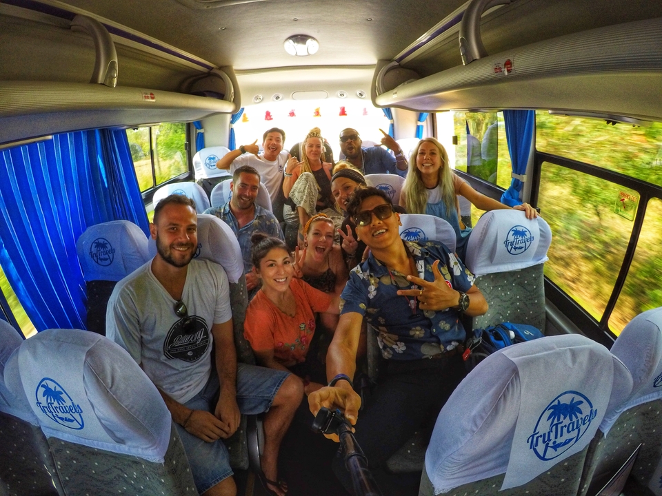 Group of people on a bus taking a selfie.