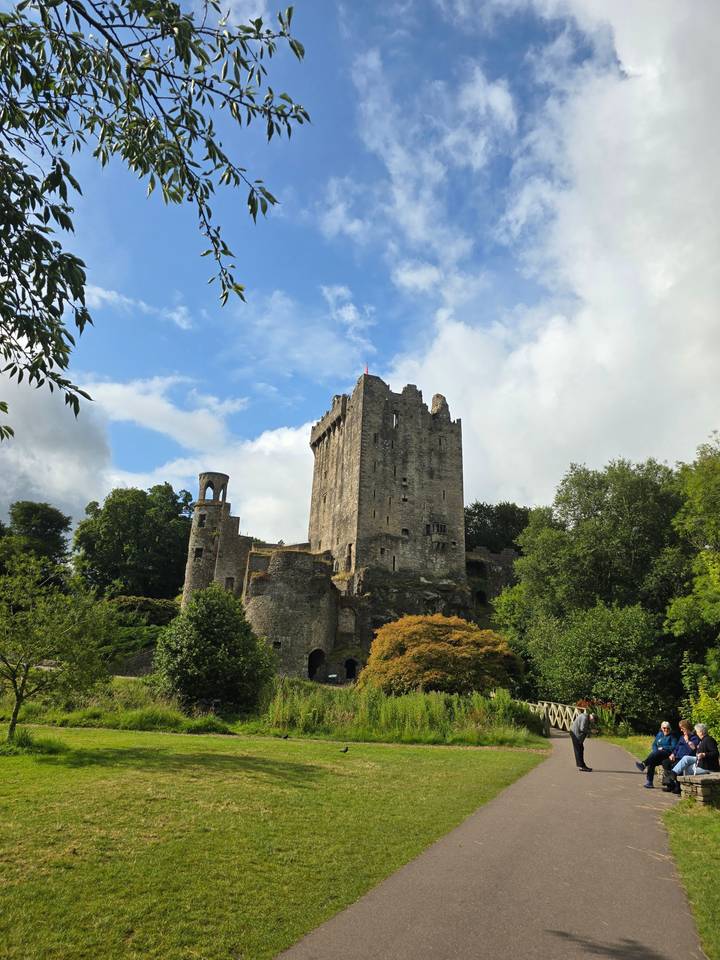 A medieval castle under a bright sky with lush grounds.