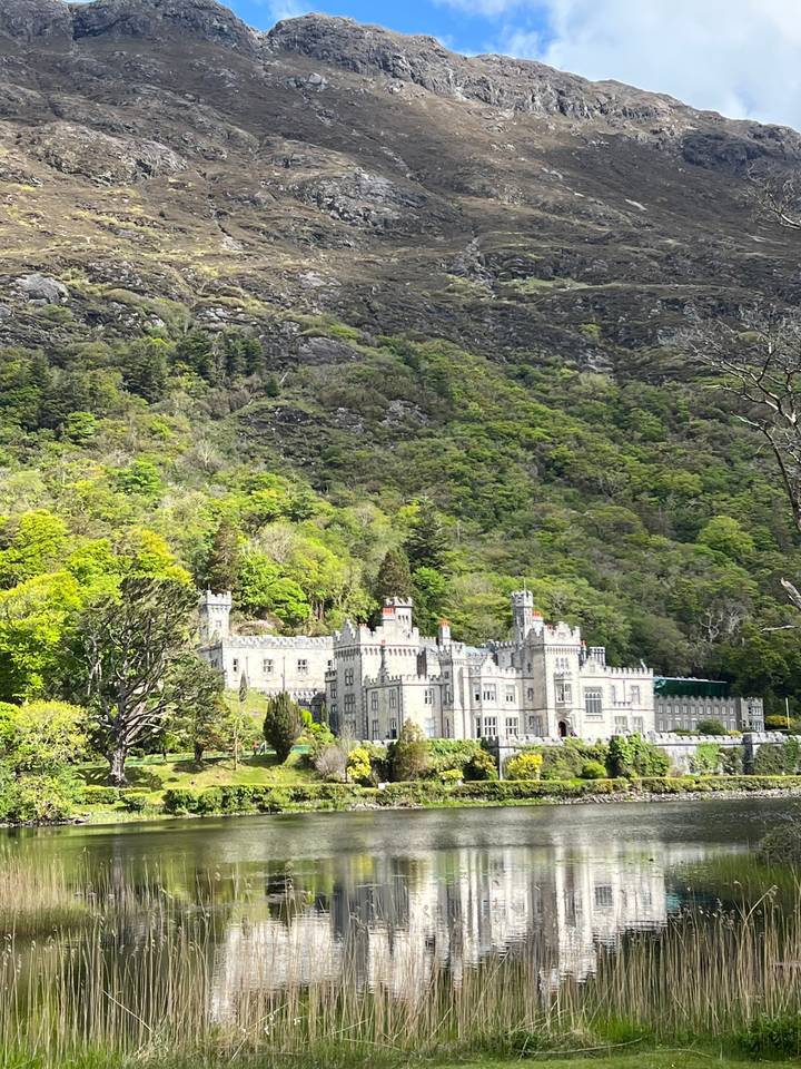 Large castle-like structure by a mountain.