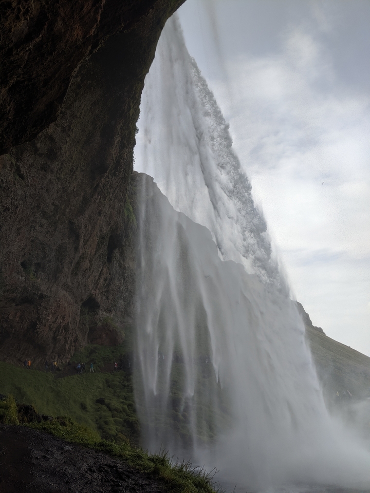 Waterfall with water streaming down a cliff at an angle.