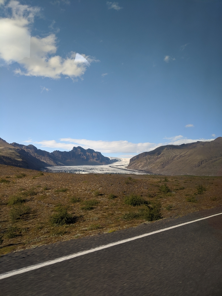 Mountainous landscape with a glacier between rocky slopes.