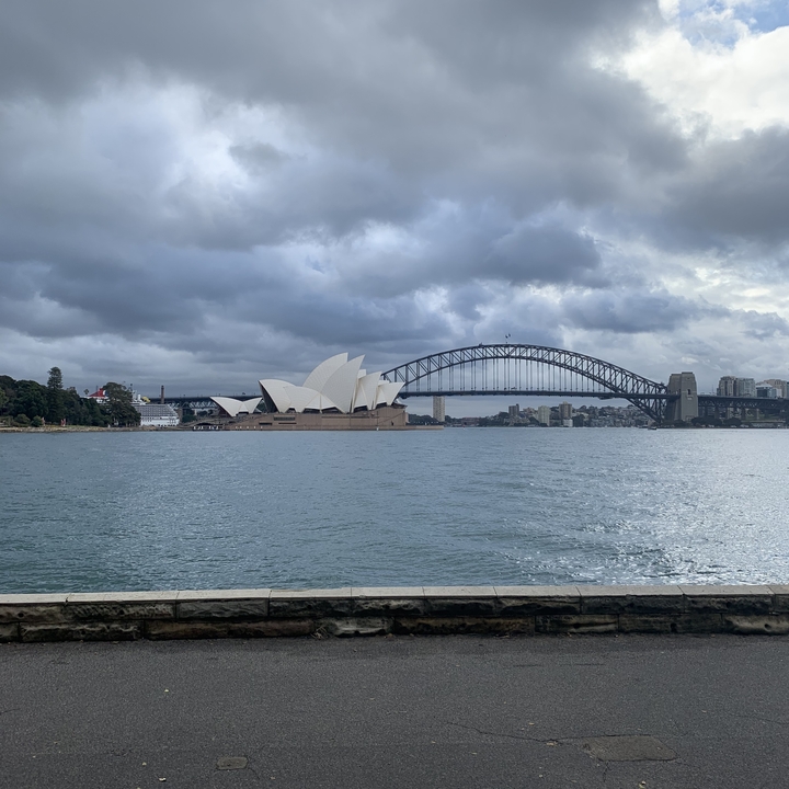 Sydney Opera House and Harbour Bridge viewed from across the water.